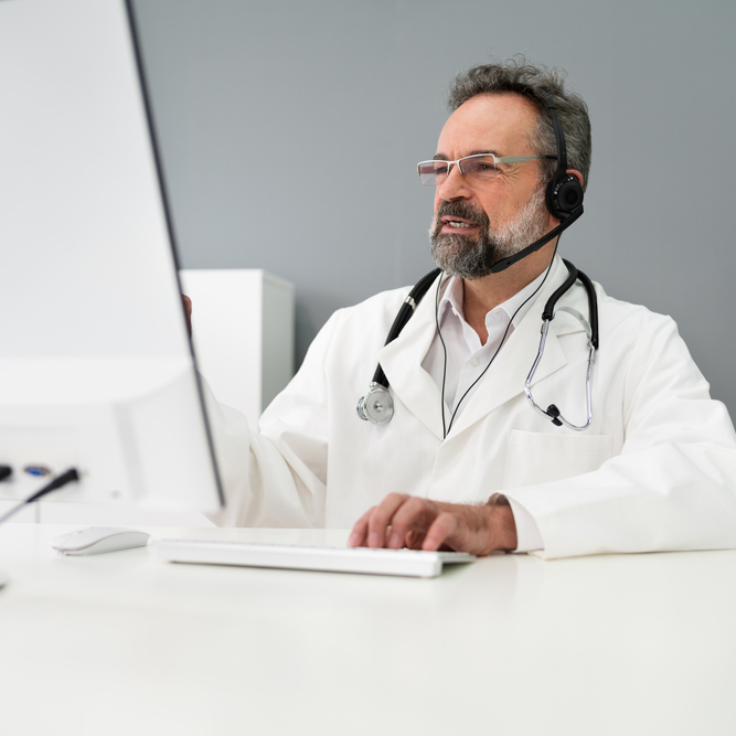 Medical doctor on phone with headset.